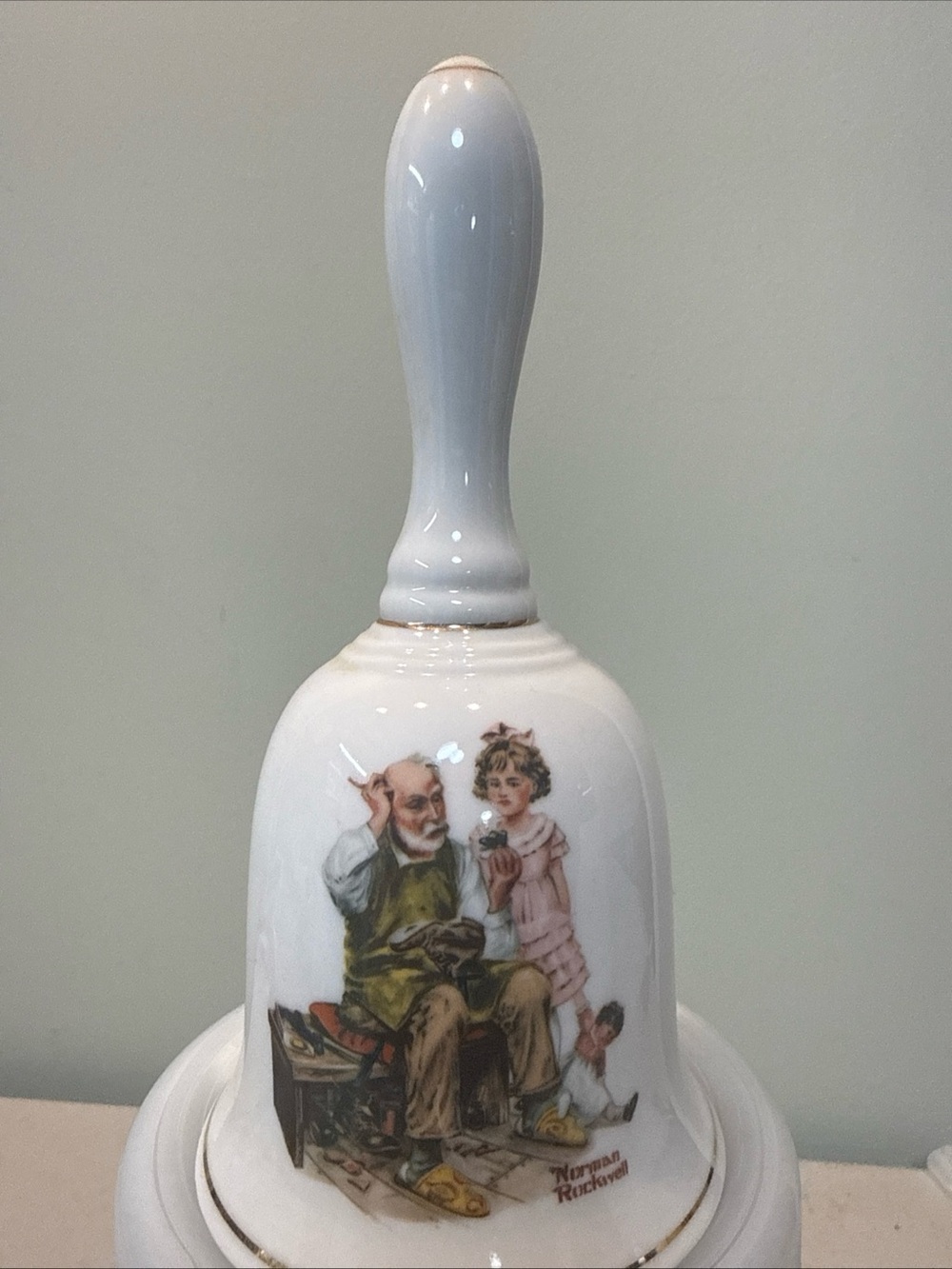 Norman Rockwell The Cobbler Porcelain Hand Painted Bell, White/Gold Trim 1986